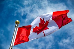 Canadian flag flying from a flagpole.