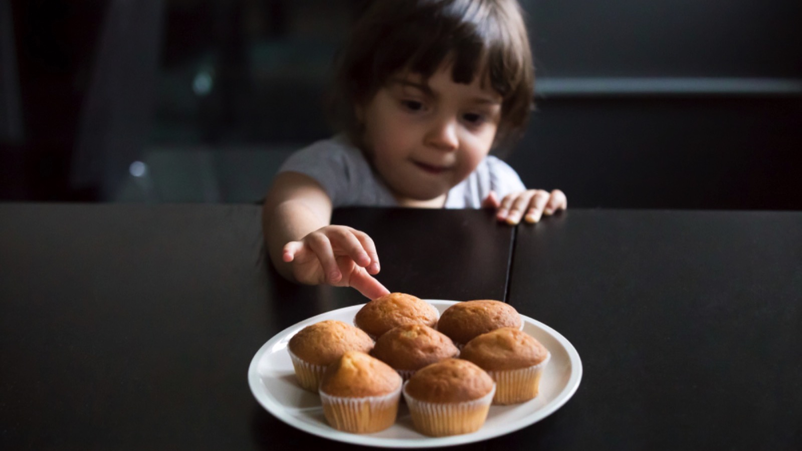 Etiquette on the Decline: Basic Manners Younger Generations Are No Longer Taught 74 Child taking cupcakes on table