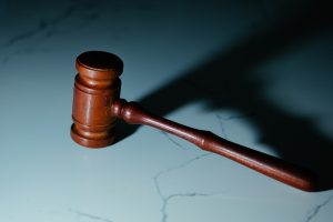 A coutroom gavel sitting on a desk.