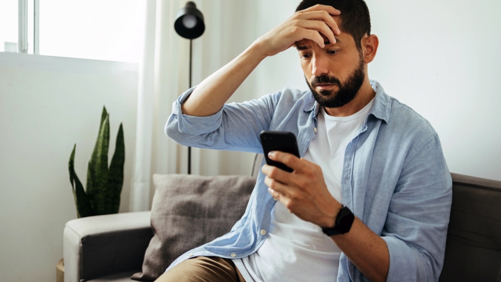 Crucial Money Mistakes Even Frugal People Make 173 Man with mobile stressed