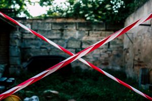 Red and white barrier tape forming an X to block a restricted area.