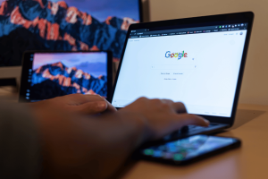 Person using Google search on laptop amid CFTC investigation into alleged Polymarket insider trading involving Google Year in Search data.
