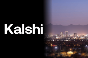 Arizona court battle against Kalshi slows amid legal scope disputes. Kalshi seeks preliminary injunction as tribes oppose Arizona betting crackdown. Kalshi challenges Arizona regulators seeks injunction over prediction market crackdown. Graphic showing the word “Kalshi” on a black background beside a nighttime skyline of Phoenix, Arizona with mountains in the distance.