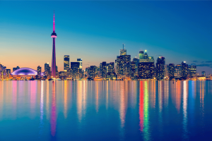 Toronto skyline at night featuring the CN Tower and illuminated downtown waterfront reflected on Lake Ontario, Canada cityscape panorama. Ontario launches centralized gambling self-exclusion system covering all regulated gaming operators