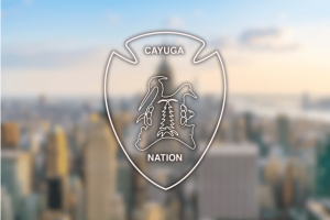 Cayuga Nation logo over New York skyline illustrating federal lawsuit against Caesars Sportsbook over alleged unauthorized sports betting on tribal reservation land