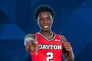 Dayton Flyers basketball player in red No. 2 jersey pointing toward camera during official team portrait. NCAA permanently bars Adam Njie after betting information sharing case