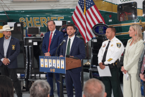 Florida Attorney General James Uthmeier announces results of a Southwest Florida illegal gambling crackdown alongside law enforcement officials, with seized gaming machines displayed during a press conference on gambling enforcement and payment processor scrutiny.