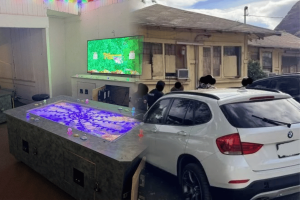 Honolulu Police Department image showing an alleged illegal gambling room in Nanakuli and officers executing a search warrant on Hakimo Road, where 14 gaming machines and cash were seized during a gambling investigation.