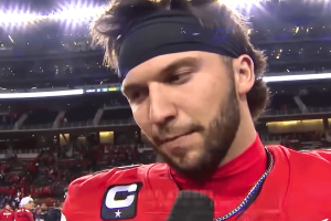 College football quarterback Brendan Sorsby wearing a red jersey and black headband speaks during a postgame sideline interview under stadium lights after a major victory. Judge clears Brendan Sorsby to return to Texas Tech after NCAA gambling-related ban