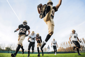 College football player leaps to catch a pass during game as NCAA player prop betting debate highlights concerns over college athlete welfare and sports betting integrity. NCAA and sportsbooks clash before Indiana Gaming Commission over college player prop bets