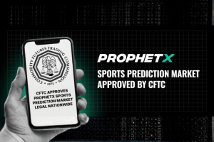 ProphetX sports prediction market receives CFTC approval in the United States, shown in a promotional graphic featuring a smartphone displaying the Commodity Futures Trading Commission seal and text announcing nationwide approval for the federally regulated sports prediction exchange.