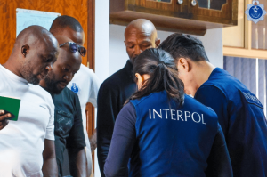 INTERPOL officers and local investigators coordinate during an international cybercrime operation targeting illegal online gambling, fraud, and money laundering networks.