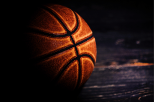 Close-up of a basketball on a hardwood court illustrating NBA betting investigation, sports gambling, match-fixing and federal corruption probe. Twelve defendants prepare guilty pleas in NBA-related rigged poker fraud case