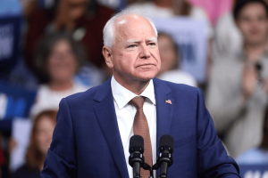 Tim Walz speaks at a campaign rally after signing Minnesota executive order restricting state employees from using confidential information on prediction market platforms.
