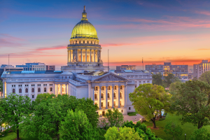 Wisconsin State Capitol building in Madison at sunset, where federal court battle over prediction markets and sports betting laws continues.