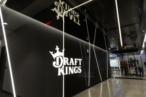 DraftKings headquarters interior with illuminated company logo as online gambling operator reports second-quarter 2026 earnings and Predictions expansion.