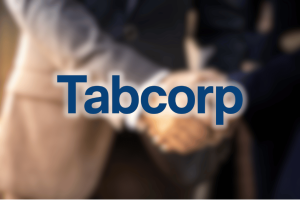 Tabcorp logo displayed over a blurred horse racing background following the company's A$267 million acquisition of BetMakers Technology Group.