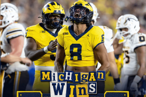 Michigan Wolverines football players celebrate a dramatic last-second victory over Western Michigan after a game-winning Hail Mary touchdown.