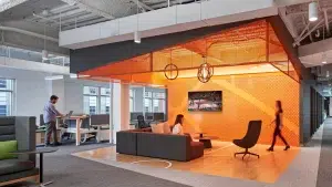 Interior of the DraftKings headquarters office in Boston featuring a lounge area with basketball-themed design elements.