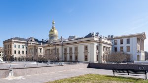 New Jersey State House in Trenton with its gold dome under a clear blue sky
