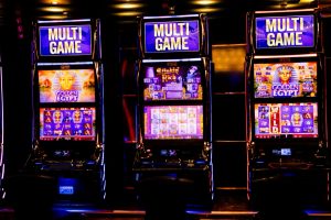 Row of illuminated slot machines in a casino